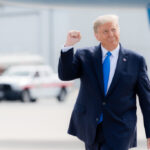 President Donald J. Trump gestures with a fist pump as he walks across the tarmac upon his arrival Thursday, Oct. 15, 2020, to Pitt-Greenville Airport in Greenville, S.C. (Official White House Photo by Shealah Craighead). Original public domain image from Flickr